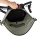 An open gray and black backpack shown from the inside, with a hand holding the top opening and a red accent panel visible at the top center, on a white background.