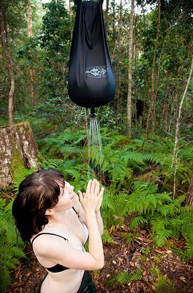 Woman showering with Sea to Summit Pocket Shower 